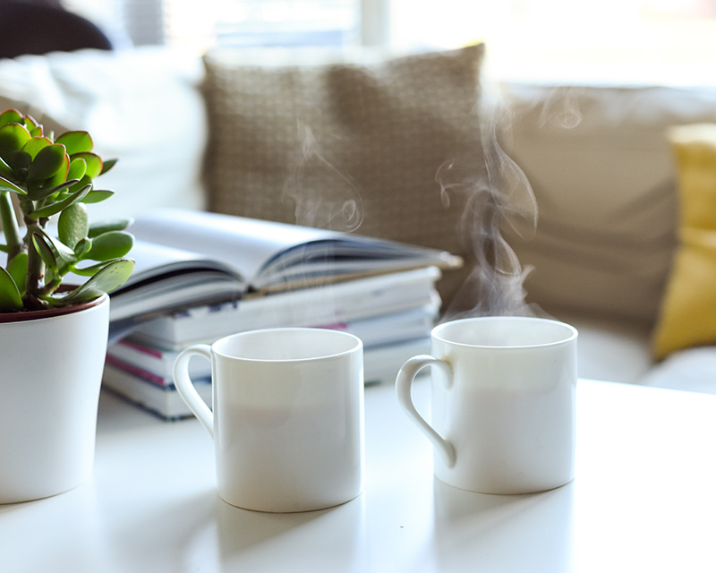 Two mugs of tea on coffee table in waiting room for Counseling for Adults in Chicago